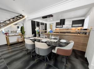 a dining room with a table and chairs at Villa avec jacuzzi, sauna&cinéma in Triel-sur-Seine