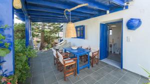 a patio with a blue table and chairs at Mediterranea Blu in Triovasálos +36 photos