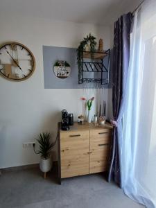 a room with a dresser and a clock on the wall at 16 Čižići in Čižići