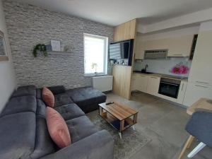 a living room with a couch and a table at 16 Čižići in Čižići