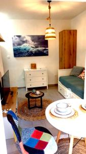 a living room with a table and a bed and a table and chairs at Bonaca Apartments in Budva
