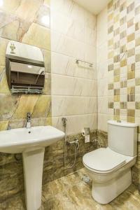 a bathroom with a white toilet and a sink at Old Baku Apartment in Baku
