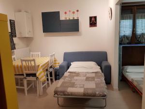 a room with a table and a bed and a table and chairs at Relax nel verde in Gravere +2 photos