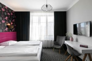 Postel nebo postele na pokoji v ubytování Liv'Inn Aparthotel