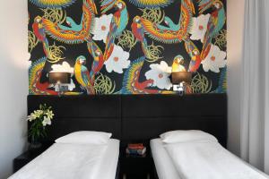 Postel nebo postele na pokoji v ubytování Liv'Inn Aparthotel