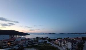 a view of a city and the ocean at dusk at ALTA MARE in Nea Peramos