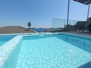 a large swimming pool with blue tiles on it at ALTA MARE in Nea Peramos