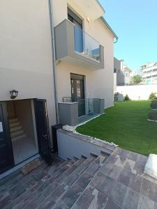 a house with a green lawn in front of it at ALTA MARE in Nea Peramos