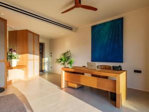 an office with a desk with a laptop on it at Petrablu Mykonos in Elia