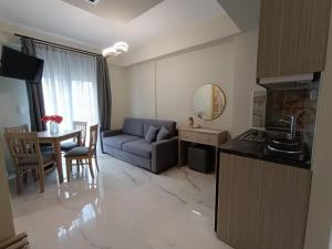 a living room with a couch and a table at ALTA MARE in Nea Peramos