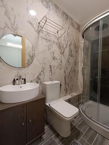 a bathroom with a toilet and a sink and a shower at ALTA MARE in Nea Peramos