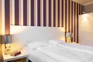 Postel nebo postele na pokoji v ubytování Liv'Inn Aparthotel