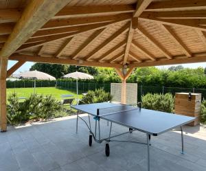 a ping pong table on a patio under a pavilion at Villa Sabbioni in Cavallino-Treporti