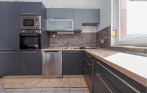a kitchen with stainless steel appliances and a window at 1 Bedroom Gorgeous Apartment In Pag in Pag