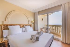 a bedroom with a large bed and a balcony at Moon Dreams Portomagno in Aguadulce