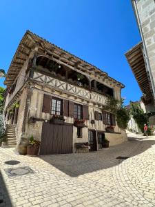 an old building with flowers on the front of it at La Maison du Coeur Calme in Cancon