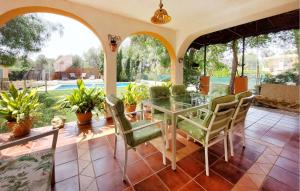 a dining room with a glass table and chairs at Awesome Home In Bétera in Bétera