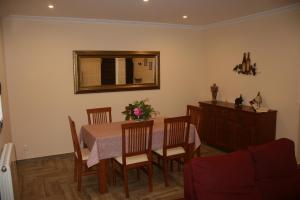 a dining room with a table and a mirror at Casa Rural Torres in Valdenoceda