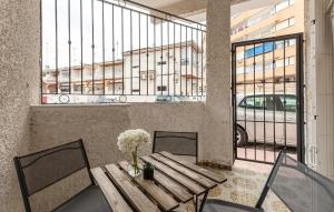 a table with a vase of flowers on top of it at Awesome Home In Torrevieja With Wifi in Torrevieja +12 photos