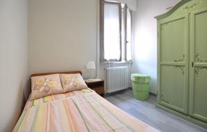 a bedroom with a bed and a green cabinet at Beautiful Apartment In Piano Di Mommio in Piano di Mommio