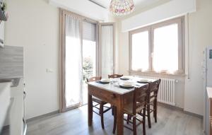 a dining room with a wooden table and chairs at Beautiful Apartment In Piano Di Mommio in Piano di Mommio