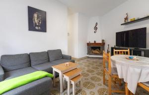 a living room with a couch and a table and a tv at Awesome Home In Torrevieja With Wifi in Torrevieja