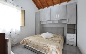 a bedroom with a bed and white cabinets at Beautiful Home In Bronte With Wifi in Maletto