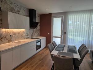 a kitchen and dining room with a table and chairs at Blue Harmony Lalzi Bay in Lalzit Bay