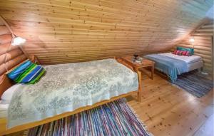 a room with two beds in a log cabin at Stunning Home In Västervik With Sauna in Västervik +4 photos