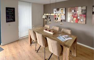 a dining room with a wooden table and chairs at 3 Bedroom Cozy Home In Lemmer in Lemmer