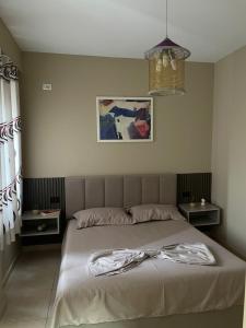 a bedroom with a bed with a robe on it at Seaside Home in Golem +10 photos