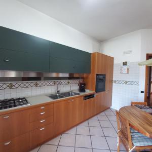 a kitchen with wooden cabinets and a sink at Casa Melina in Nola
