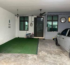a garage with a car parked in it at Homestay D' Bertam Apisuzie in Kampong Alor
