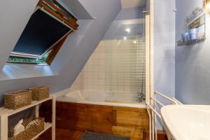 a bathroom with a tub and a sink at Moulin de la Grenaderie in Sergeac +20 photos