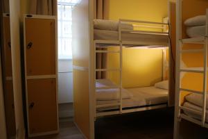 a room with two bunk beds and a window at Safestay Edinburgh Cowgate in Edinburgh
