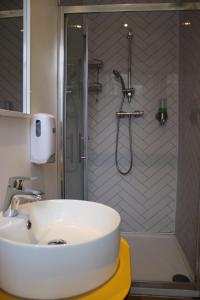 a bathroom with a sink and a shower at Safestay Edinburgh Cowgate in Edinburgh