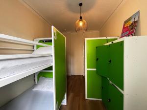 a room with green and white bunk beds at Safestay Edinburgh Cowgate in Edinburgh