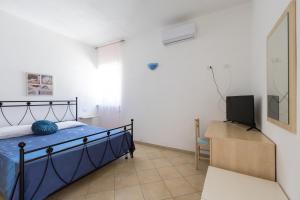 a bedroom with a bed and a desk and a television at Casa Vacanze Villa Francesca in Peschici +36 photos