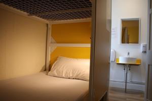 a small bedroom with a bunk bed and a sink at Safestay Edinburgh Cowgate in Edinburgh
