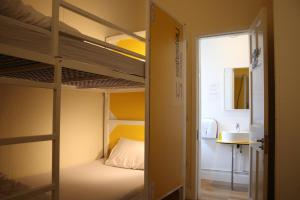 a room with two bunk beds and a sink at Safestay Edinburgh Cowgate in Edinburgh