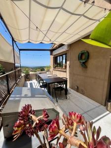 an outdoor patio with a table and a patio umbrella at Begur, mon amour in Begur +42 photos
