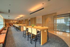 an office cafeteria with a long table and chairs at Morich Suites Antasari in Jakarta +36 photos
