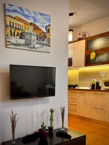a living room with a flat screen tv on a wall at All Seasons Apartments - Free Parking & City Center in Shkodër