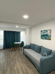 a living room with a couch and a table at Olimp Sea View 607 in Olimp