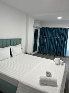 a bedroom with a large bed with towels on it at Olimp Sea View 607 in Olimp