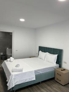 a bedroom with a large bed with white sheets at Olimp Sea View 607 in Olimp