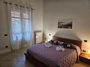 a bedroom with a bed with two stuffed animals on it at Fiore di LOTO in Paratico