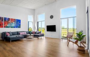 a living room with a couch and a tv at Beautiful Home In Børkop With Sauna in Børkop