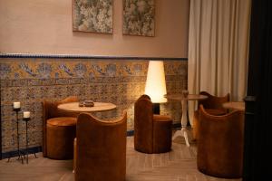 a room with a table and chairs and a lamp at Honest Sevilla Hotel in Seville