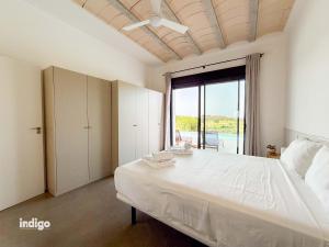 a bedroom with a large bed and a large window at Villa Paz -Moderno Privado Nuevo Piscina Vistas a Golf y Lago in Ayamonte +27 photos